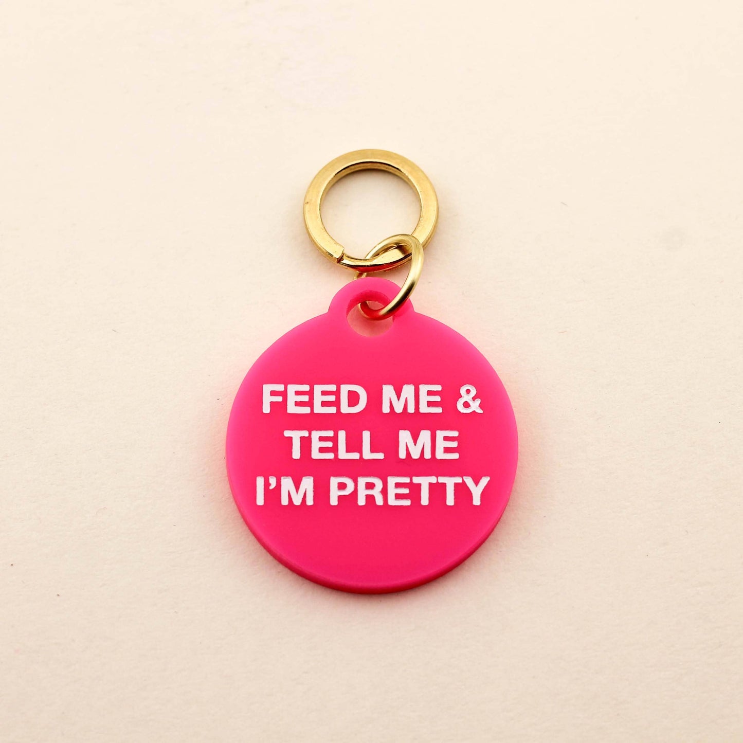 Designed for our customers who have a big obsession with their four-legged friend! Our Feed Me & Tell Me I'm Pretty Pet Tag comes in our high-quality Barbie Pink Acrylic! Pet tags are sold individually Size: 1.25" L by 1.4" H Made of high-quality acrylic with color-fill Handcrafted in Augusta, Georgia